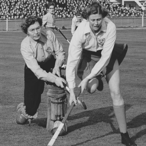 1956 Vera Chapman playing at Wembley Stadium in the England v Holland match Black and white photo of England and Holland hockey players attempting to gain control of the hockey ball | Courtesy of The Hockey Museum