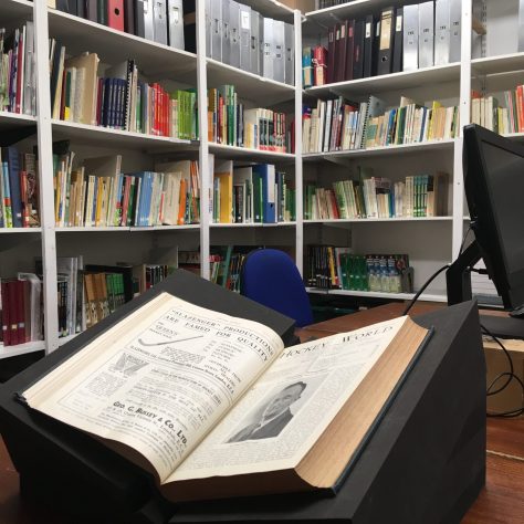 High-Street_library-01 Book of hockey history propped open on a desk in front of bookshelves | Courtesy of The Hockey Museum