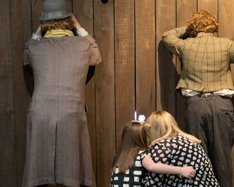 Mannequins and Museum guests peek through a fence | Scottish Football Museum