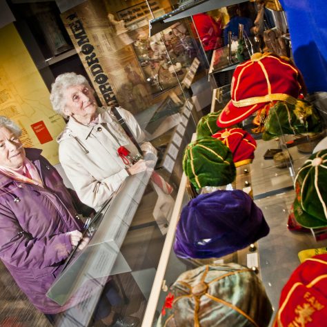 Wrexham Museum pics Two women viewing the caps on display in the Welsh Football collection | Image courtesy of the Welsh Football Collection