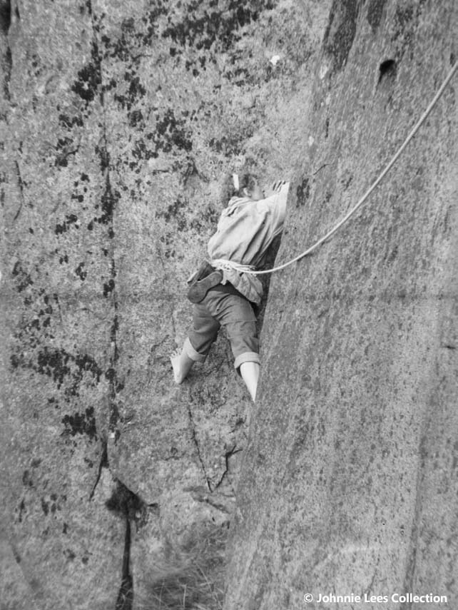 Gwen Moffat climbing a sheer rock face, with a rope as harness. | © Johnnie Lees Collection, supplied by the Mountain Heritage Trust