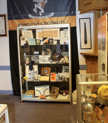 The Story of the U's – cabinet and flag Various items in a display cabinet at The Story of the U's museum | The Story of the U's