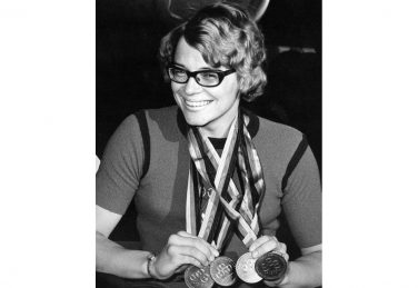 Black and white photo of Carol Bryant with her four gold medals | @ Caz Walton