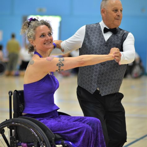 A standing partner A female wheelchair user dancing with a man standingdancing. | ParaDance