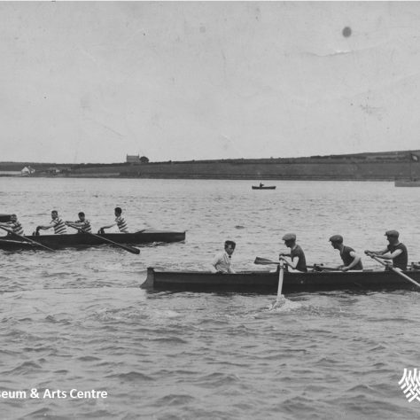 Rowing in Larne Lough Black and white photo of three rowing teams in Larne Lough | Larne Museum & Arts Centre / Mid & East Antrim Borough Council