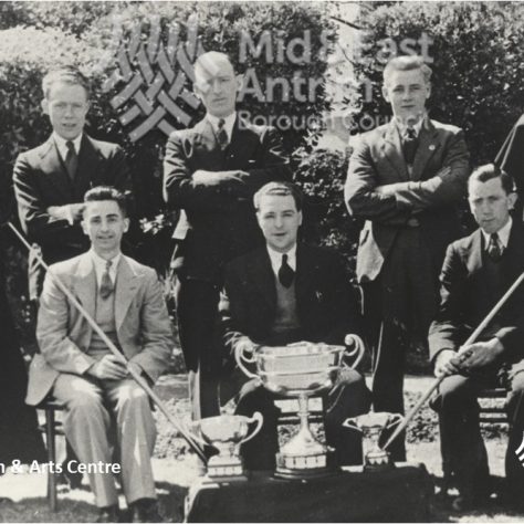 Black and white team photo with three trophies | Larne Museum & Arts Centre / Mid & East Antrim Borough Council