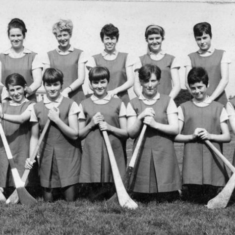 Black and white team photo of women on a field holding bats | Fermanagh County Museum