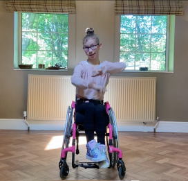 A girl in a wheelchair takes part in a Street Dance session