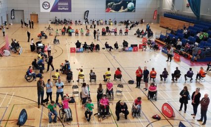 Wide shot of people playing Boccia in a sportshall | Boccia England