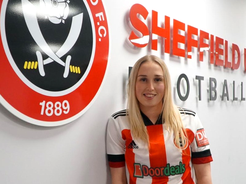 Woman standing in front of Sheffield United crest | Sheffield United FC