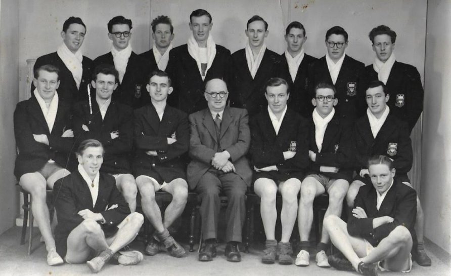 Posed photo of team wearing blazers over athletics kit