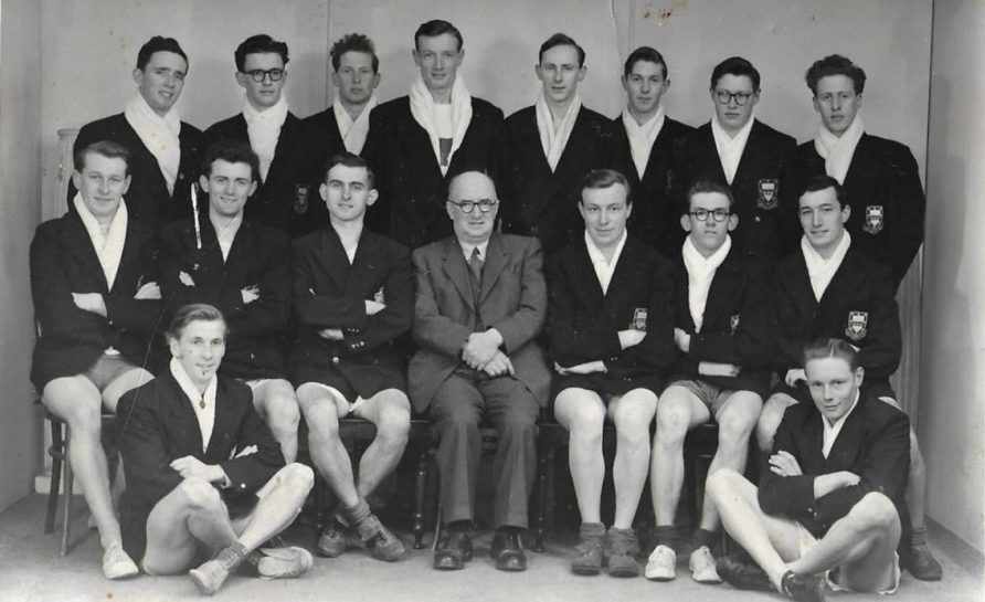 Posed photo of team wearing blazers over athletics kit | Teulu Dr Colin Morgan