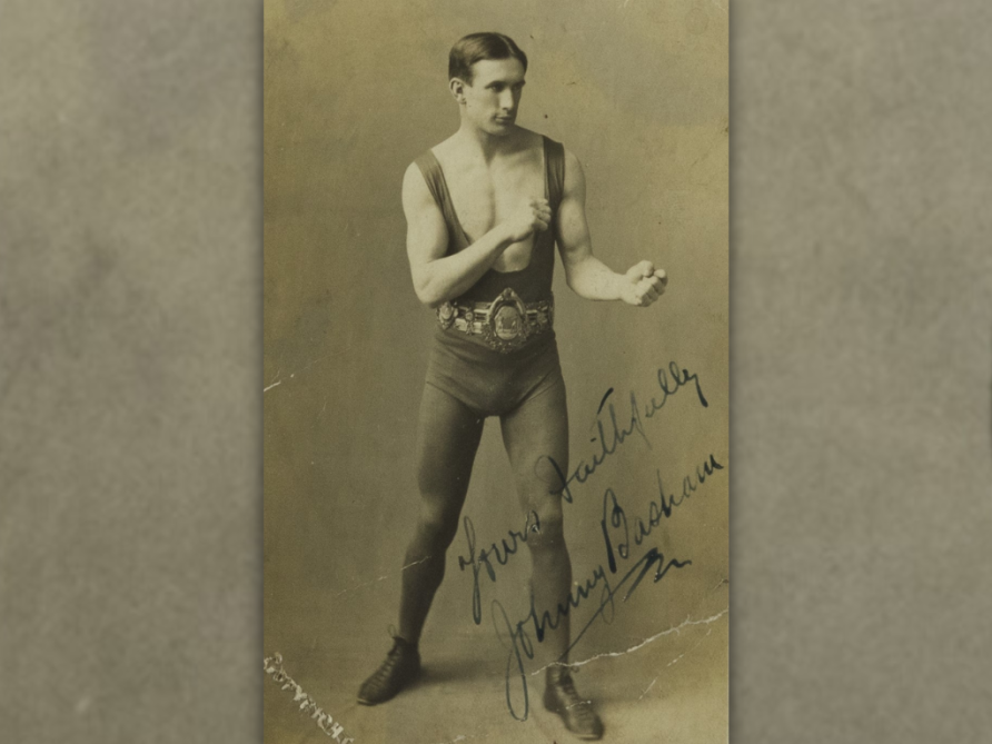Autographed photo of Johnny Basham in boxing pose, wearing Lonsdale Belt over vest, shorts and leggings | Royal Welch Fusiliers Museum