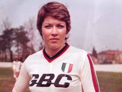 Rose Reilly wears GBC sponsored Milan shirt with Scudetto crest, pitch in background