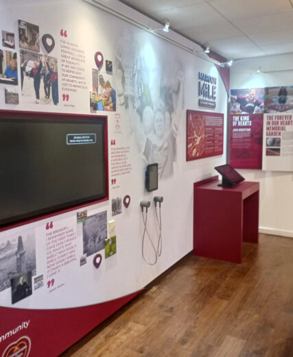 Gallery space showing information boards and touchscreens.