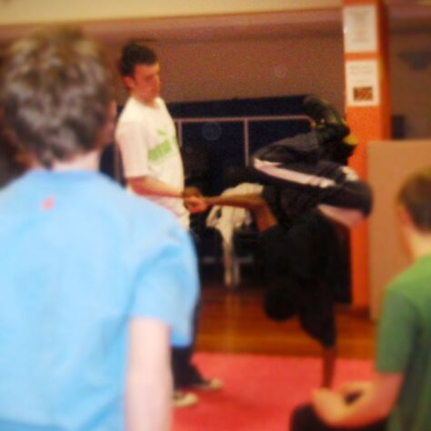 2009 March - Bruno - Deaf Centre - St Helens 2 One Break Dancer is upside down on one hand, whilst others crowd around | UC Crew