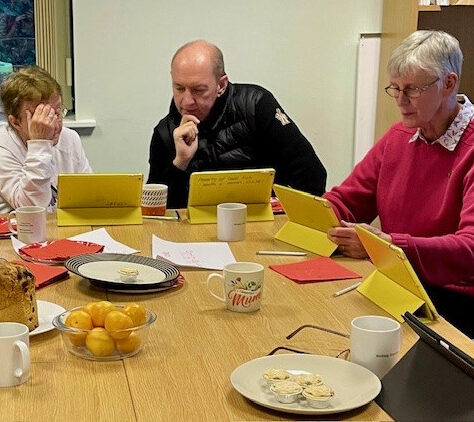 A digital inclusion session looking at the Croke Park Virtual Museum. LIHH A group of people looking at iPads | Leeds Irish Health & Homes
