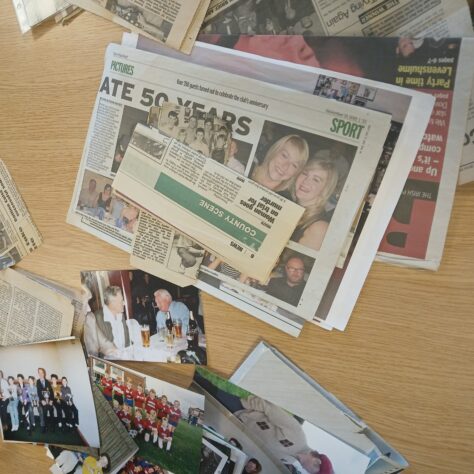 Reminiscence material. LIHH Some photographs and newspapers on a table. | Leeds Irish Health & Homes